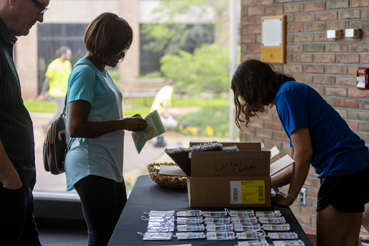 A woman standing in front of the registration table at the 2024 NetVUE regional gathering at Calvin University.