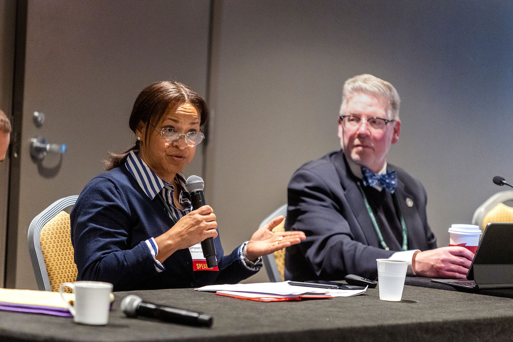 A woman speaking into a microphone.