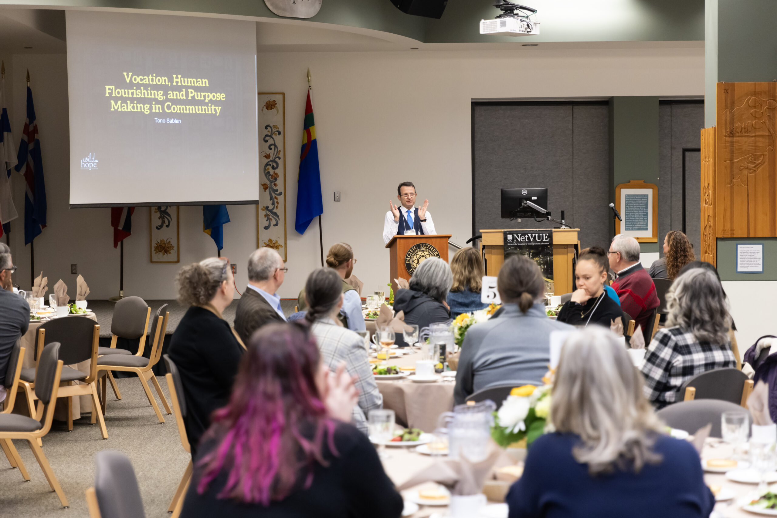 A speaker presenting to a room of participants at the 2025 NetVUE gathering at Pacific Lutheran University.