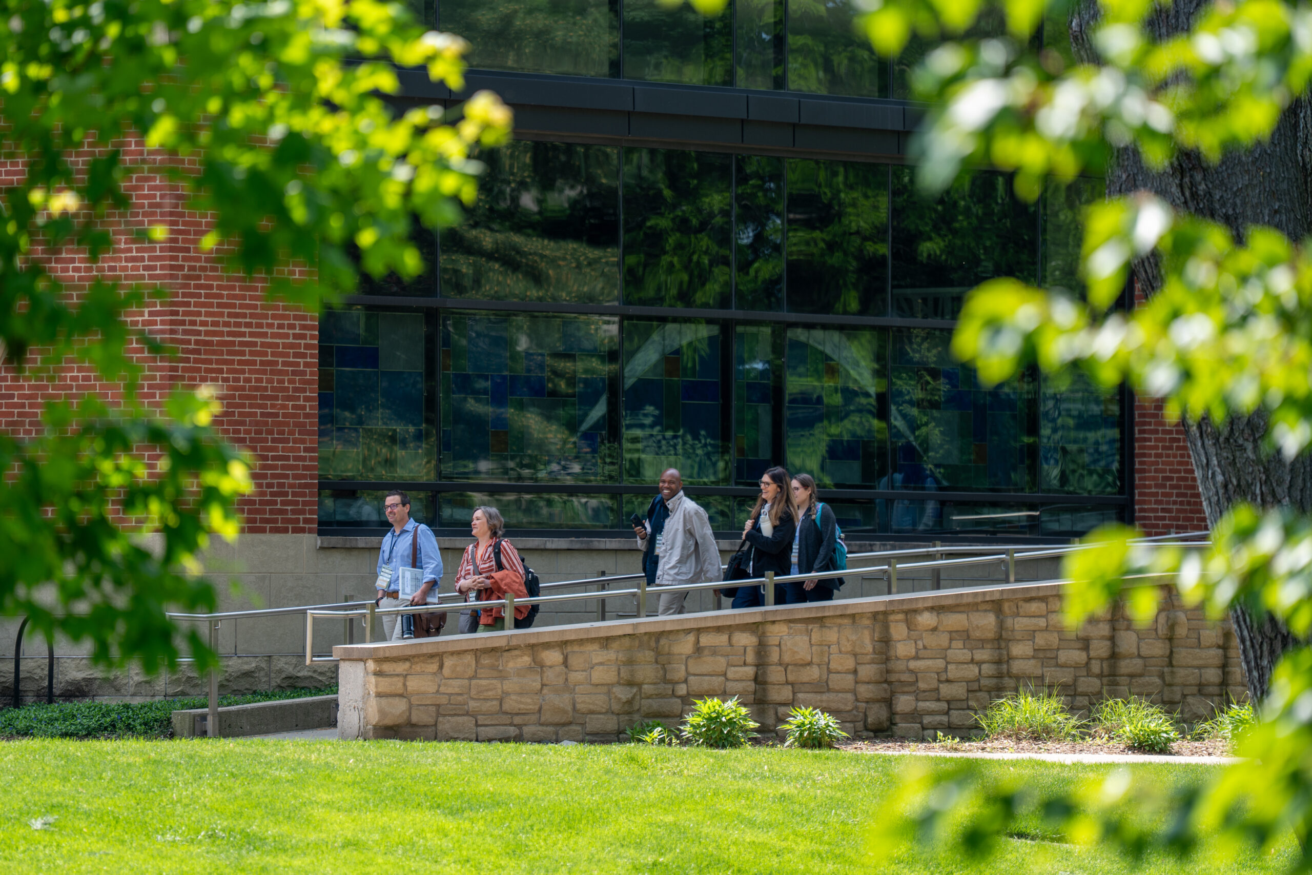 A group of people walking in between buildings during the 2025 NetVUE regional gathering at Hope College.