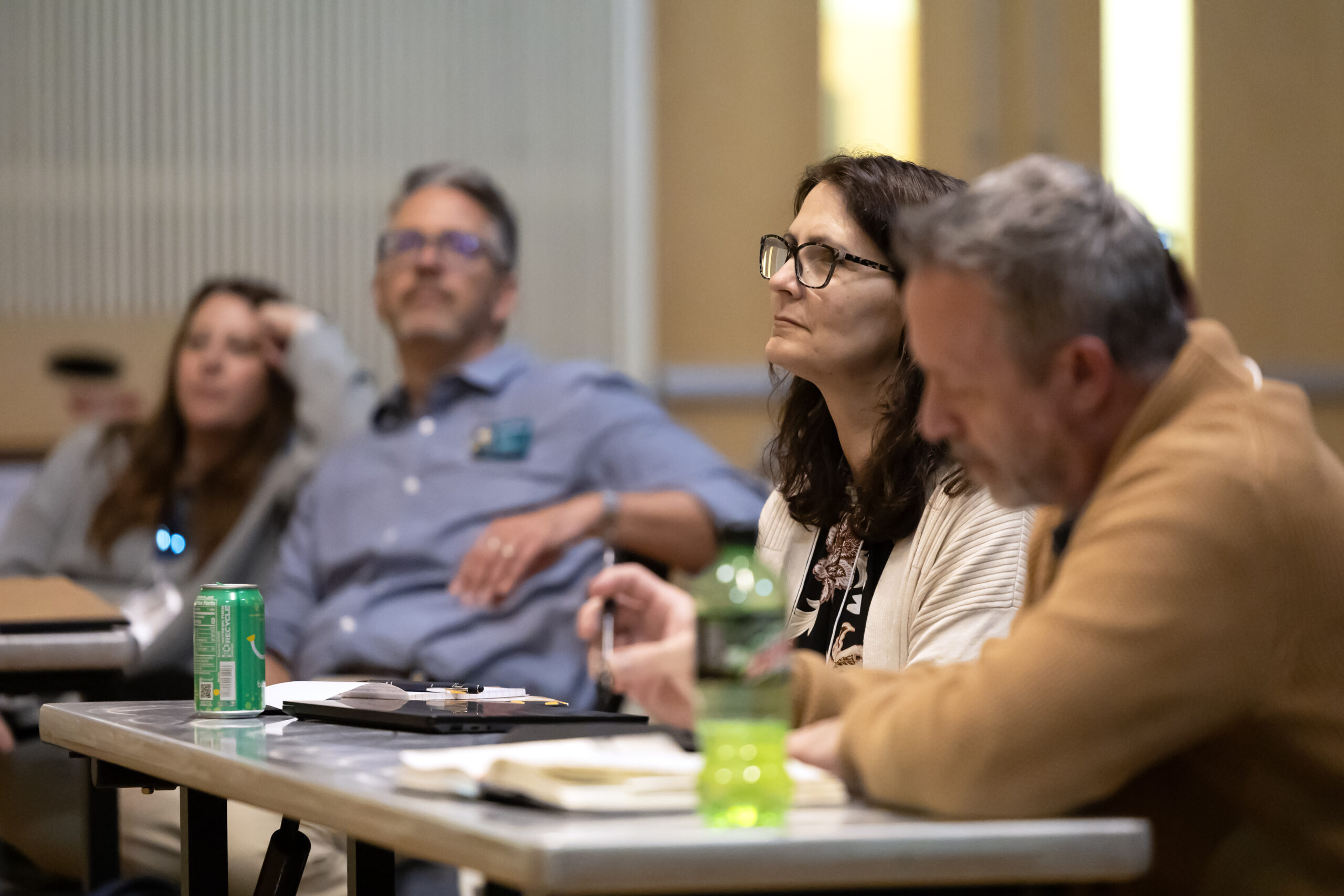 A woman listens to a speaker at the 2025 NetVUE regional gathering at Pacific Lutheran University.