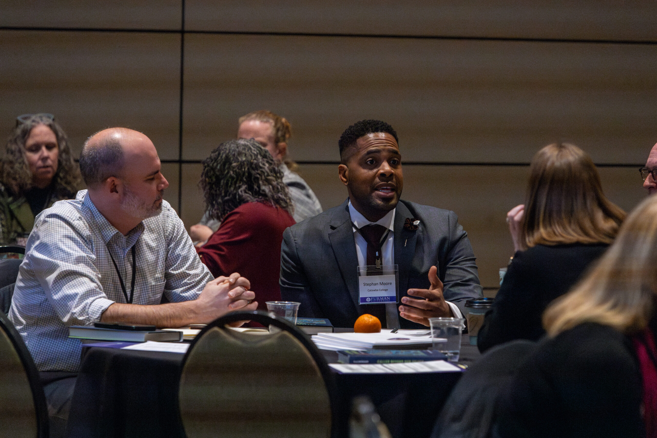 A man speaks to his colleagues during a discussion at the 2024 NetVUE regional gathering hosted by Furman University.