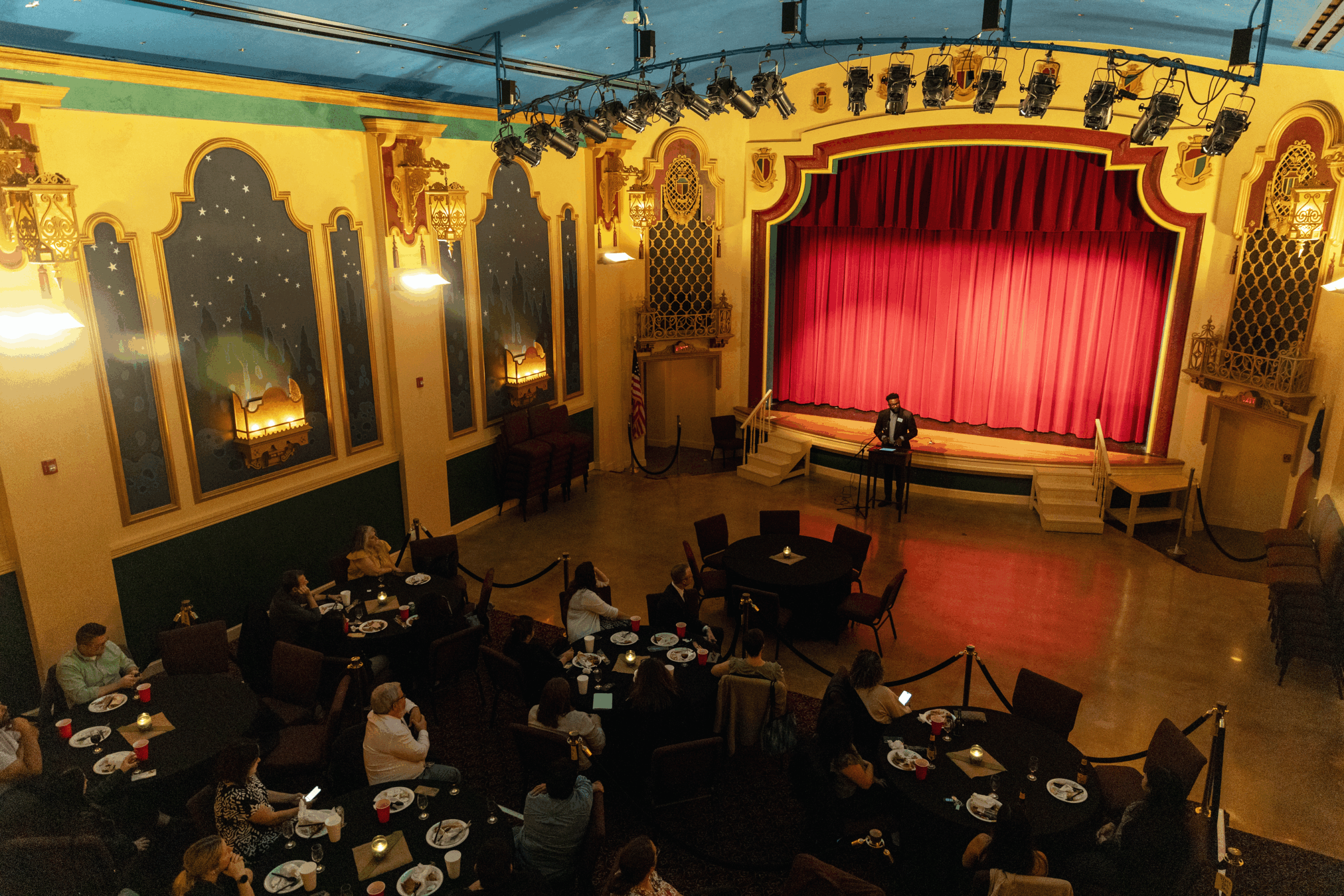 Rev. Lamont Anthony Wells presents to participants at the Texas Theatre in downtown Seguin during the welcome dinner of the 2024 NetVUE regional gathering hosted by Texas Lutheran University.