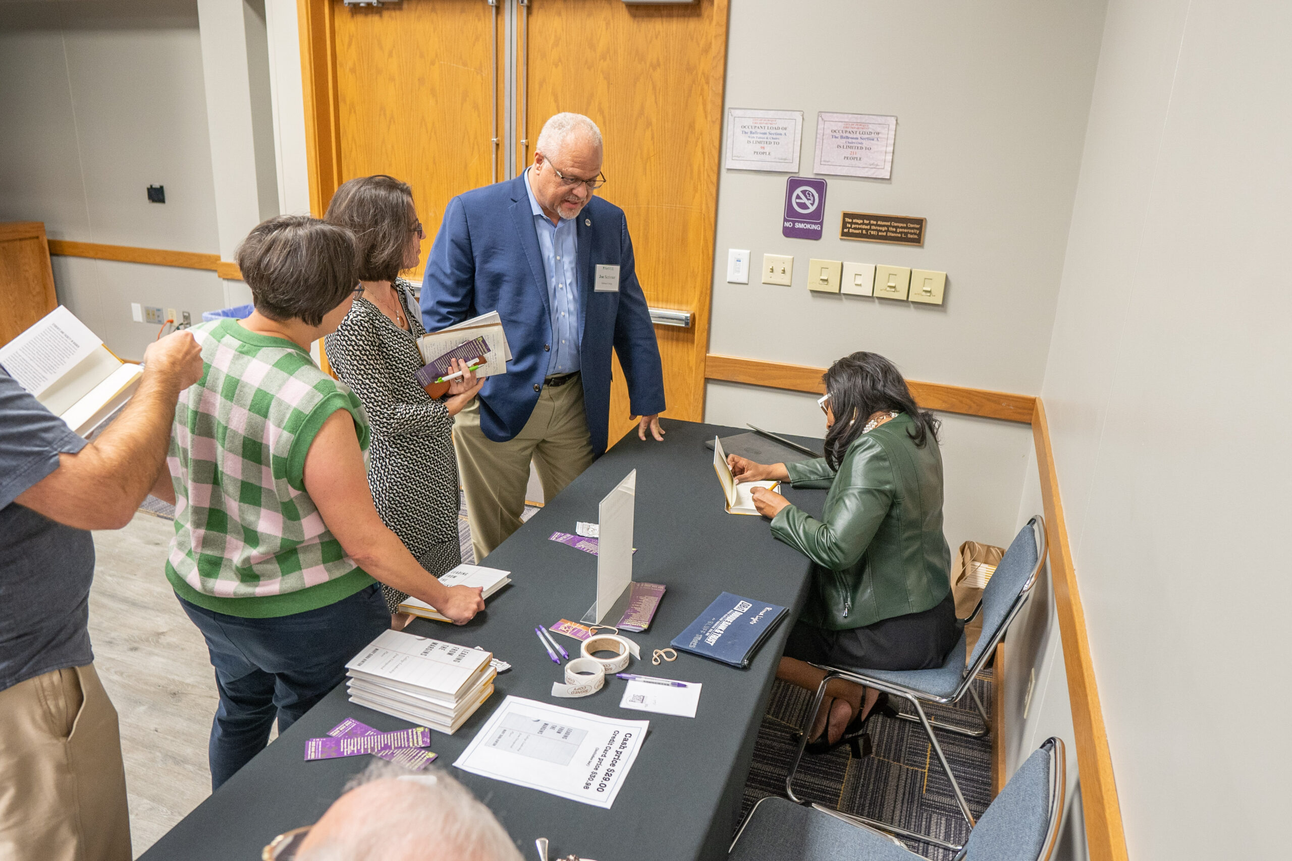 Mary Dana Hinton signing books after her presentation at the 2024 NetVUE 