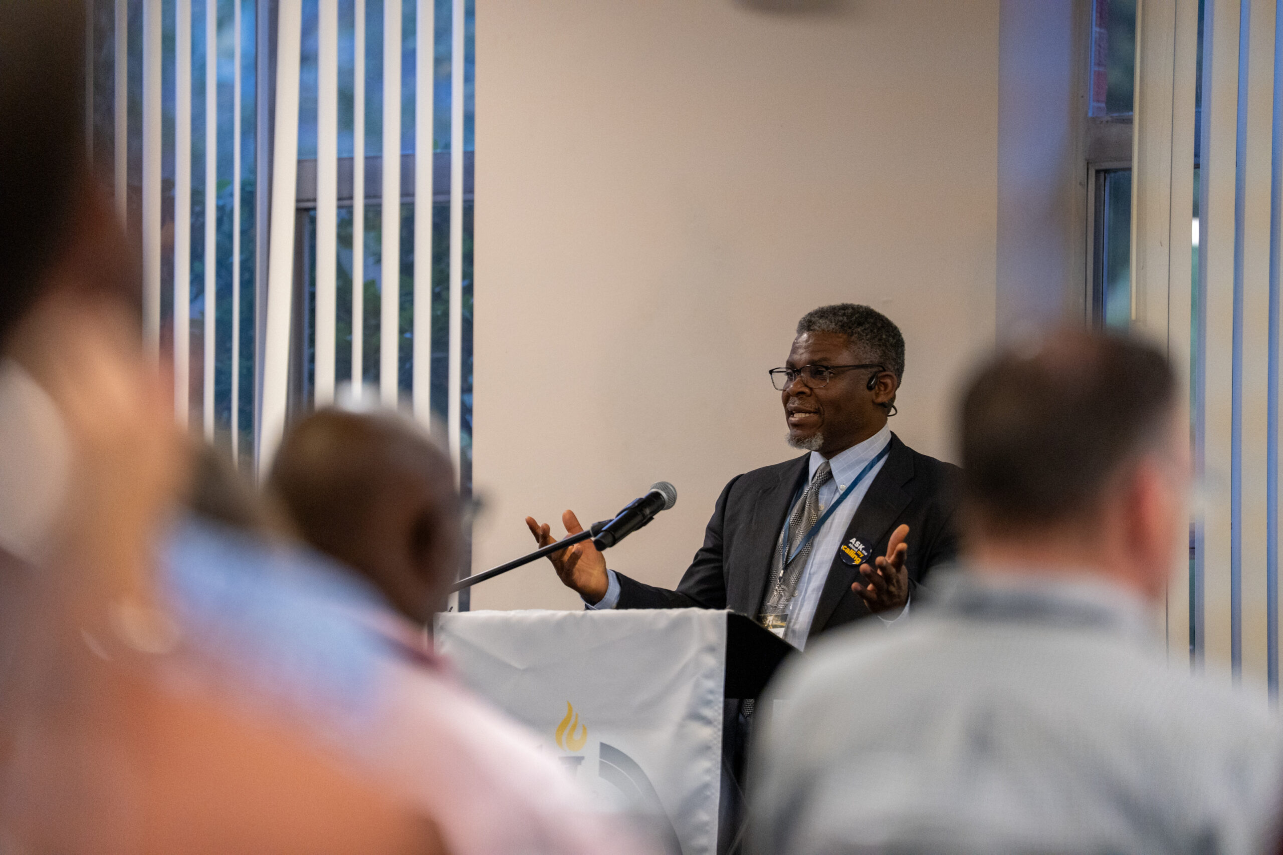 A speaker presents to the participants of the 2025 NetVUE regional gathering hosted by Bushnell University, 'The Purposeful University.'